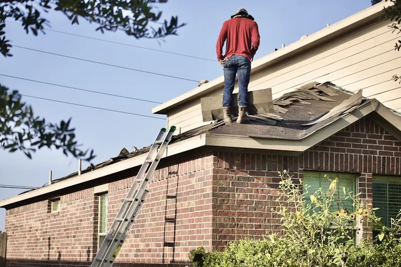 Professional roofer working on a residential roof in Quogue